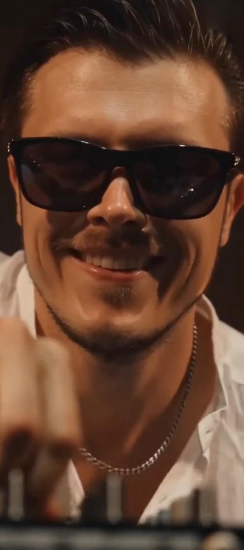Close-up of ROOM:SRVC DJ Sascha smiling at the decks