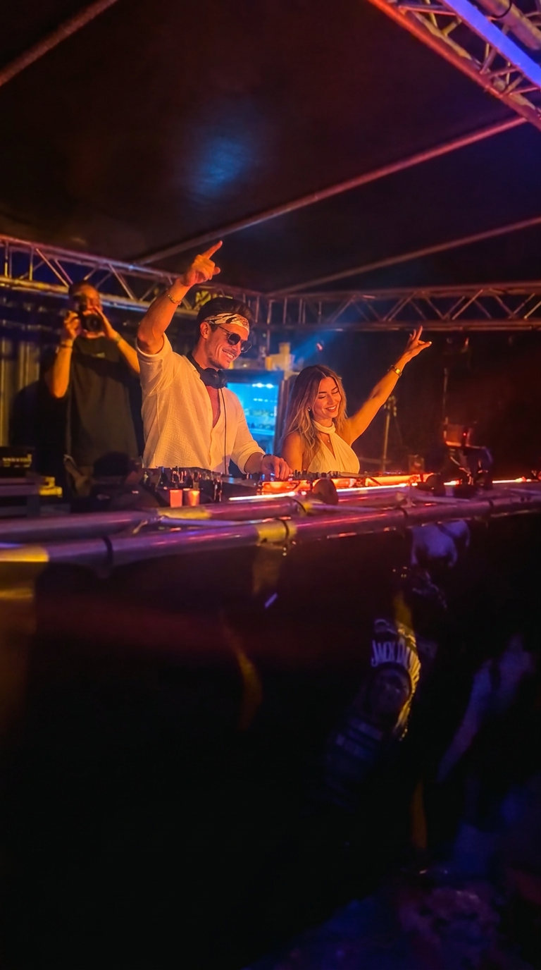 ROOM:SRVC DJ duo Sascha and Olivia performing on a festival stage under a light show